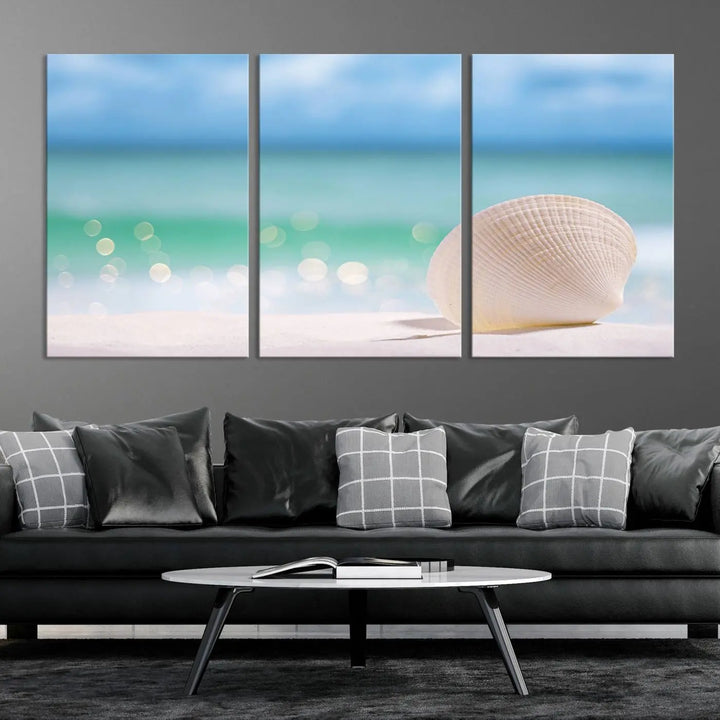 The "Seashell on The Beach Wall Art Canvas Print" features a triptych photo of a seashell on a sandy beach. This artwork is printed on gallery-wrapped, museum-quality canvas with a UV-protective coating.