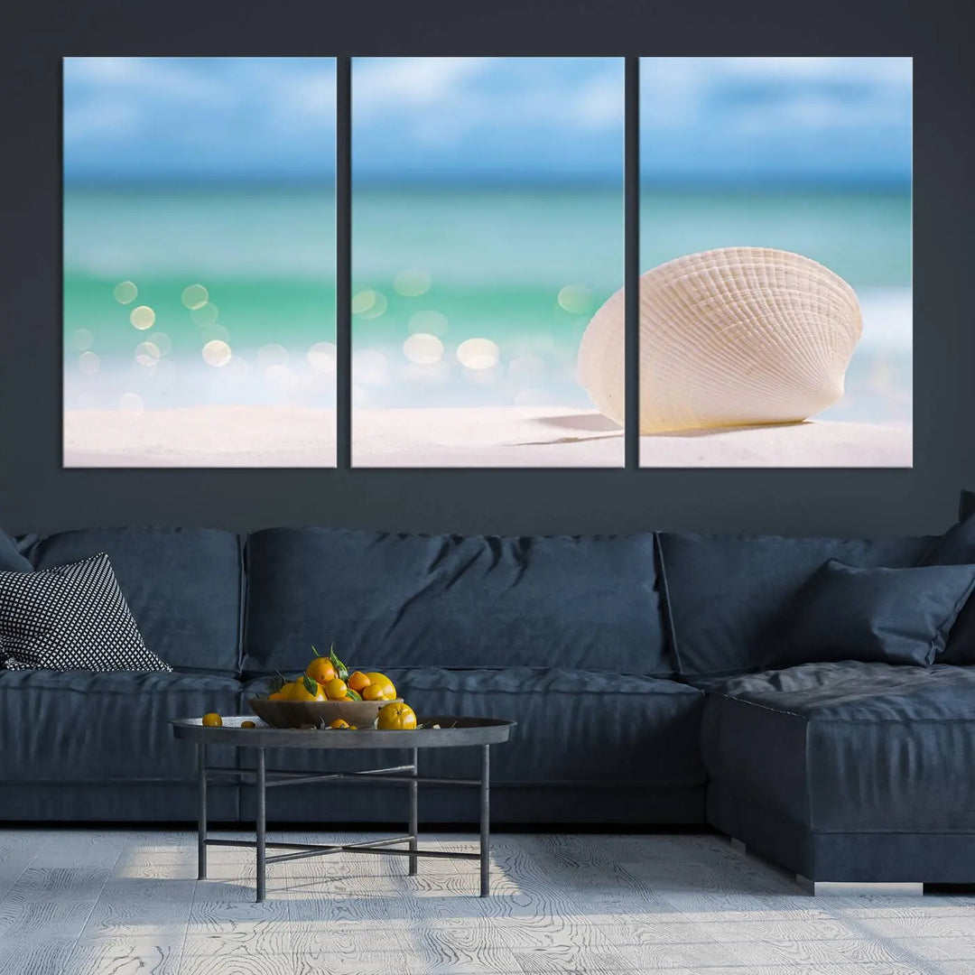 The "Seashell on The Beach Wall Art Canvas Print" features a triptych photo of a seashell on a sandy beach. This artwork is printed on gallery-wrapped, museum-quality canvas with a UV-protective coating.