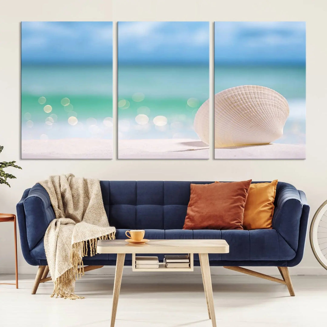 The "Seashell on The Beach Wall Art Canvas Print" features a triptych photo of a seashell on a sandy beach. This artwork is printed on gallery-wrapped, museum-quality canvas with a UV-protective coating.