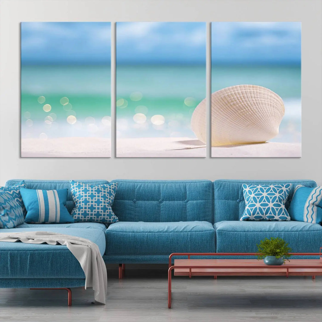 The "Seashell on The Beach Wall Art Canvas Print" features a triptych photo of a seashell on a sandy beach. This artwork is printed on gallery-wrapped, museum-quality canvas with a UV-protective coating.