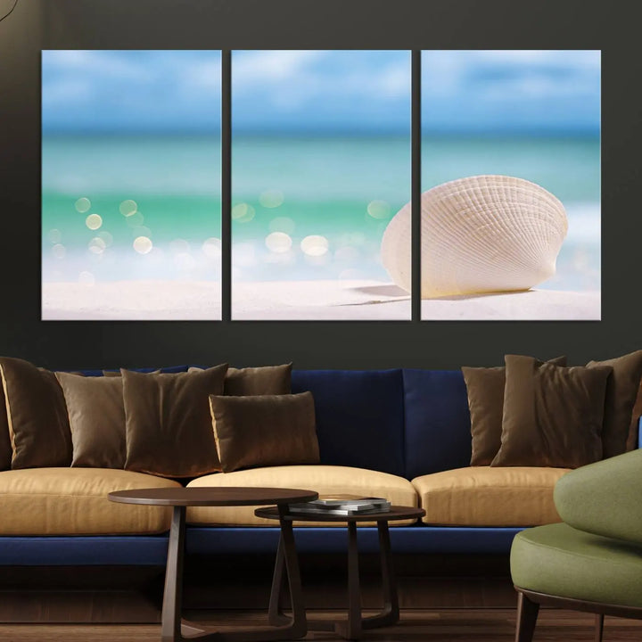 The "Seashell on The Beach Wall Art Canvas Print" features a triptych photo of a seashell on a sandy beach. This artwork is printed on gallery-wrapped, museum-quality canvas with a UV-protective coating.