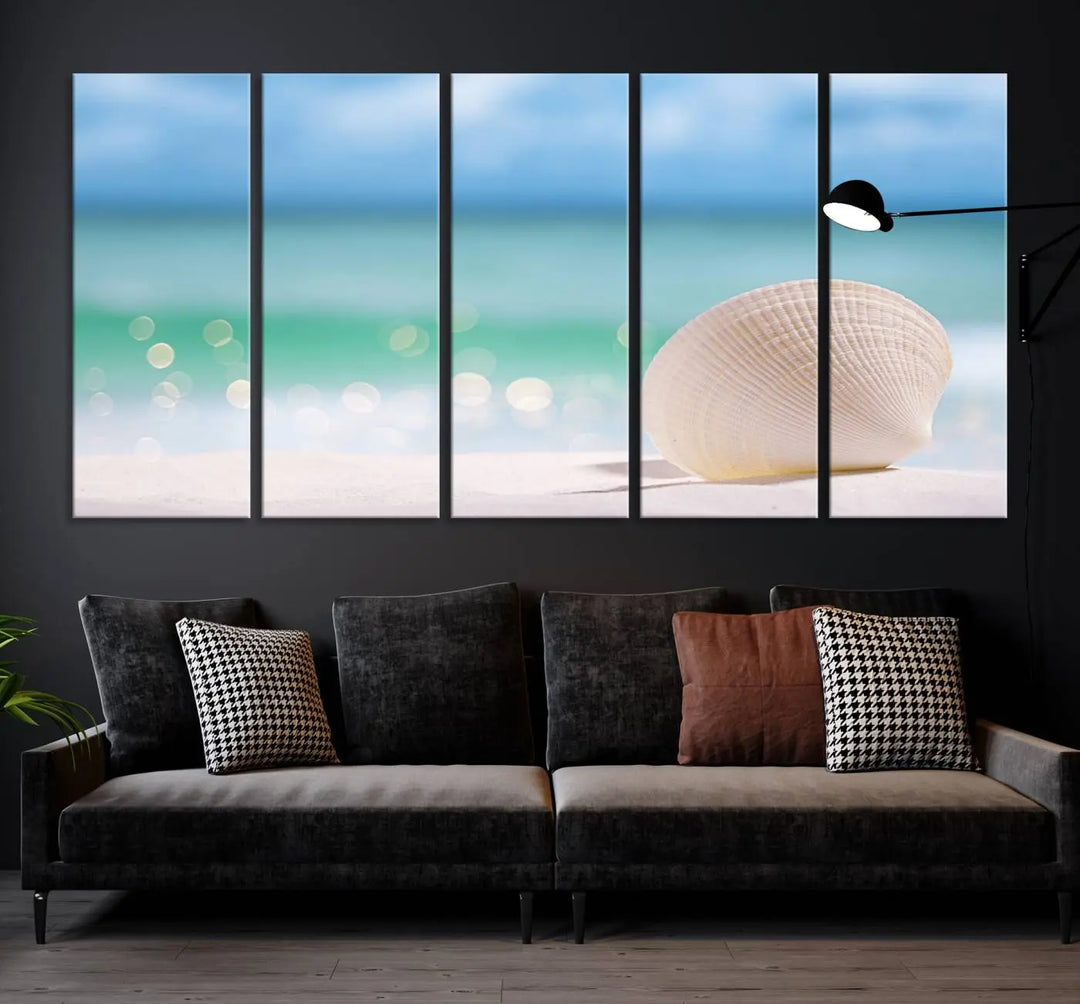 The "Seashell on The Beach Wall Art Canvas Print" features a triptych photo of a seashell on a sandy beach. This artwork is printed on gallery-wrapped, museum-quality canvas with a UV-protective coating.