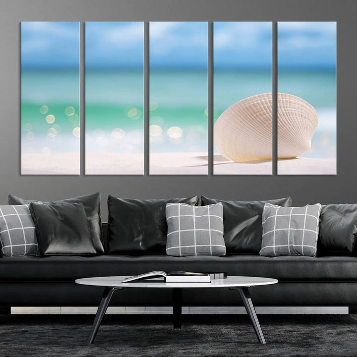 The "Seashell on The Beach Wall Art Canvas Print" features a triptych photo of a seashell on a sandy beach. This artwork is printed on gallery-wrapped, museum-quality canvas with a UV-protective coating.