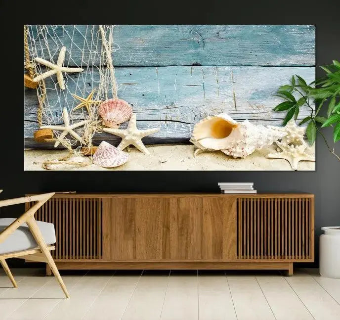 The beautiful three-panel canvas print, "Seashells on Rustic Wooden Background," features seashells and starfish against a blue wood background. The gallery-wrapped panels are coated with UV protection to ensure long-lasting vibrancy.