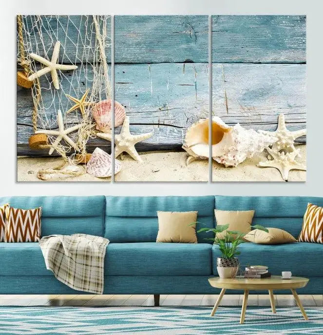 The beautiful three-panel canvas print, "Seashells on Rustic Wooden Background," features seashells and starfish against a blue wood background. The gallery-wrapped panels are coated with UV protection to ensure long-lasting vibrancy.