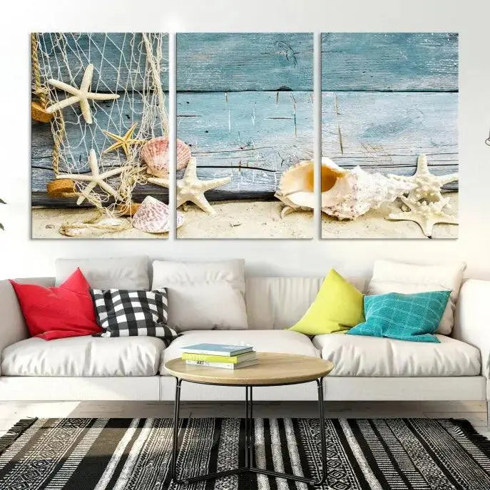 The beautiful three-panel canvas print, "Seashells on Rustic Wooden Background," features seashells and starfish against a blue wood background. The gallery-wrapped panels are coated with UV protection to ensure long-lasting vibrancy.