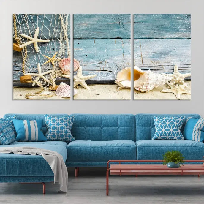 The beautiful three-panel canvas print, "Seashells on Rustic Wooden Background," features seashells and starfish against a blue wood background. The gallery-wrapped panels are coated with UV protection to ensure long-lasting vibrancy.