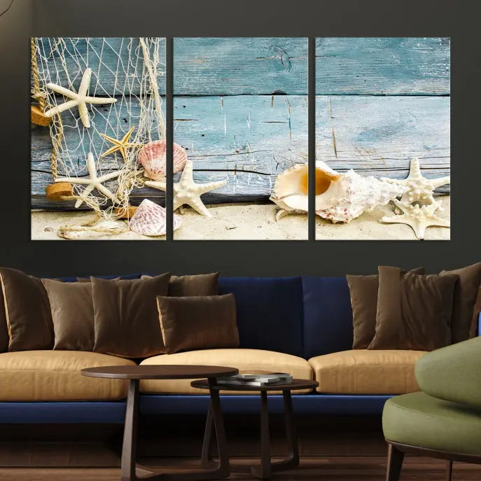 The beautiful three-panel canvas print, "Seashells on Rustic Wooden Background," features seashells and starfish against a blue wood background. The gallery-wrapped panels are coated with UV protection to ensure long-lasting vibrancy.