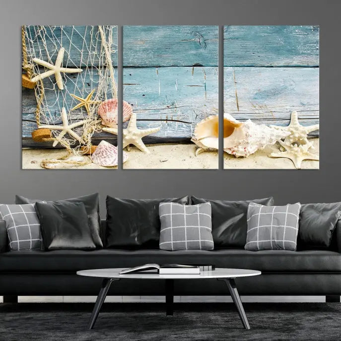 The beautiful three-panel canvas print, "Seashells on Rustic Wooden Background," features seashells and starfish against a blue wood background. The gallery-wrapped panels are coated with UV protection to ensure long-lasting vibrancy.