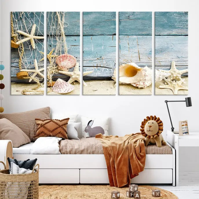 The beautiful three-panel canvas print, "Seashells on Rustic Wooden Background," features seashells and starfish against a blue wood background. The gallery-wrapped panels are coated with UV protection to ensure long-lasting vibrancy.