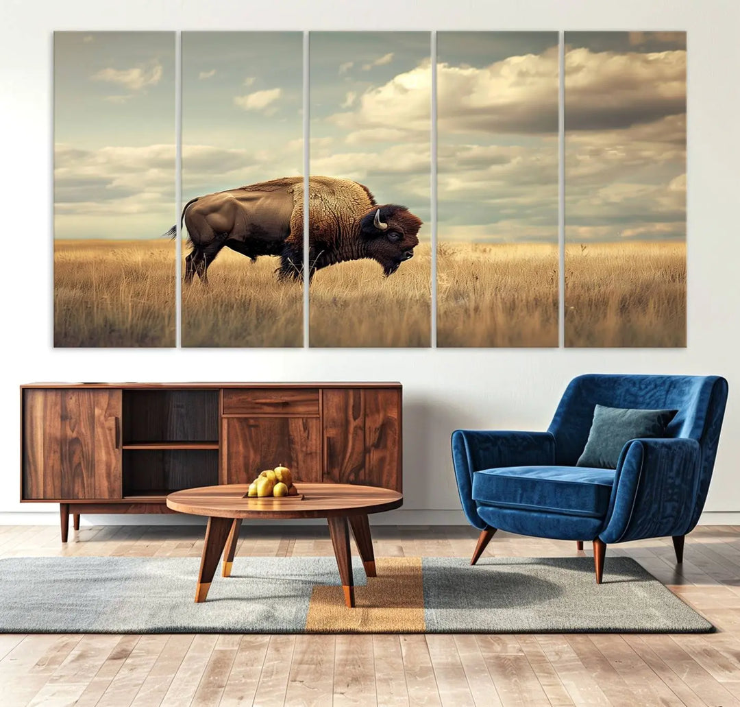 The Sepia American Bison Wall Art Print, a Western canvas print, depicts a bison standing in a grassy field beneath a cloudy sky. This high-resolution museum-quality triptych wall art is ideal for farmhouse wall decor.