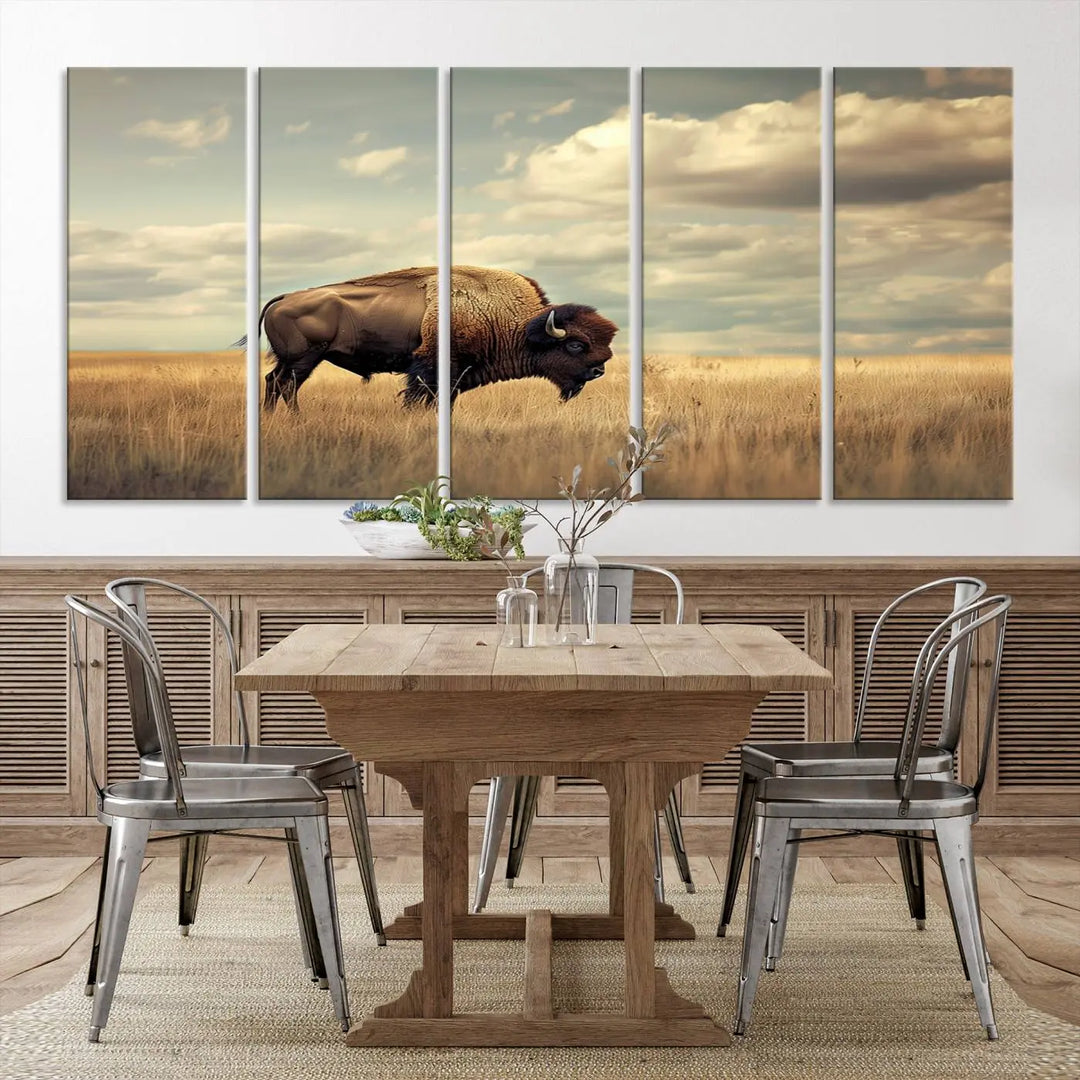 The Sepia American Bison Wall Art Print, a Western canvas print, depicts a bison standing in a grassy field beneath a cloudy sky. This high-resolution museum-quality triptych wall art is ideal for farmhouse wall decor.