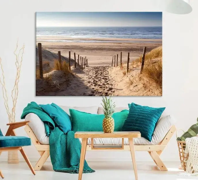 The "Serene Beach Path Canvas – Coastal Landscape Wall Art Triptych – Tranquil Ocean View for Living Room" is tastefully displayed, adding a beautiful coastal touch to the room's ambiance.