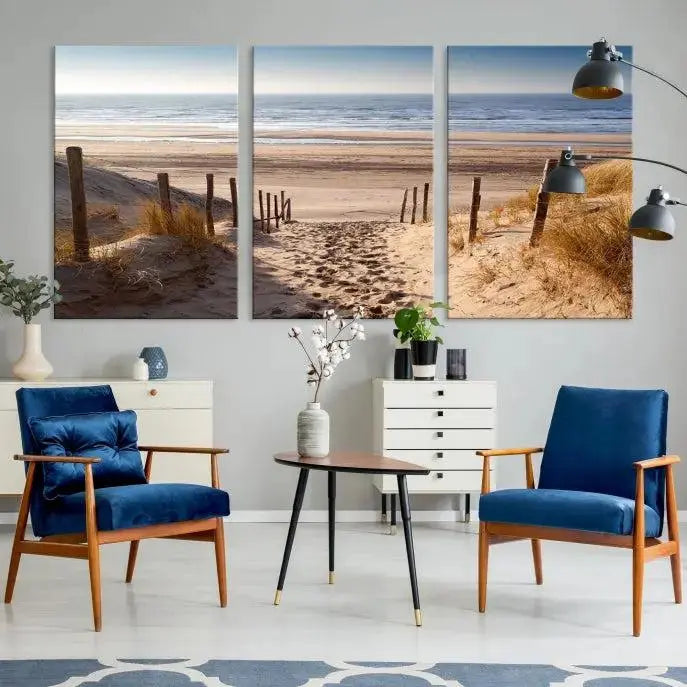 The "Serene Beach Path Canvas – Coastal Landscape Wall Art Triptych – Tranquil Ocean View for Living Room" is tastefully displayed, adding a beautiful coastal touch to the room's ambiance.