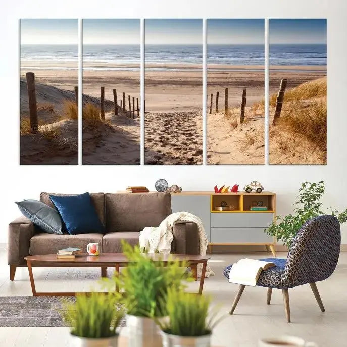 The "Serene Beach Path Canvas – Coastal Landscape Wall Art Triptych – Tranquil Ocean View for Living Room" is tastefully displayed, adding a beautiful coastal touch to the room's ambiance.