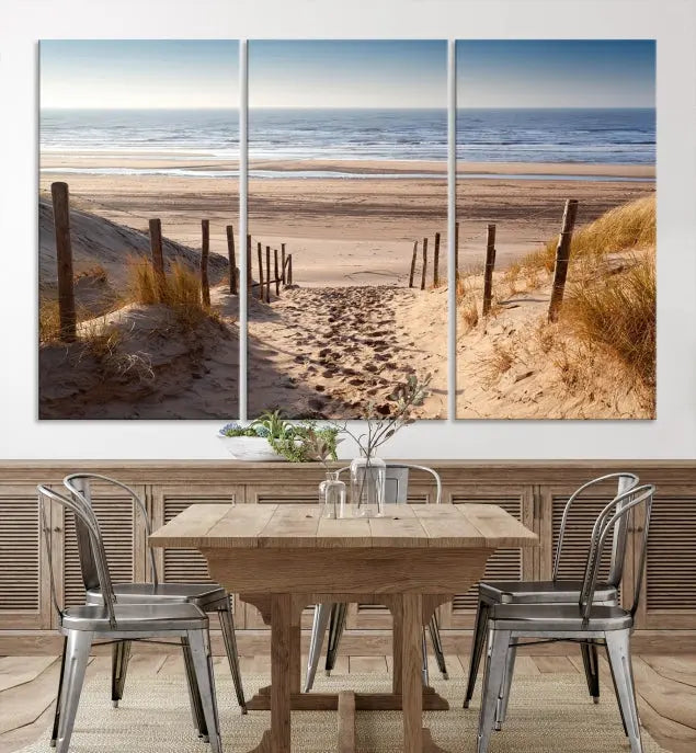 The "Serene Beach Path Canvas – Coastal Landscape Wall Art Triptych – Tranquil Ocean View for Living Room" is tastefully displayed, adding a beautiful coastal touch to the room's ambiance.