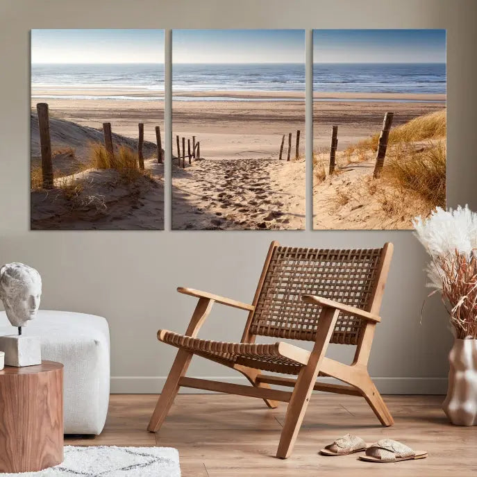 The "Serene Beach Path Canvas – Coastal Landscape Wall Art Triptych – Tranquil Ocean View for Living Room" is tastefully displayed, adding a beautiful coastal touch to the room's ambiance.