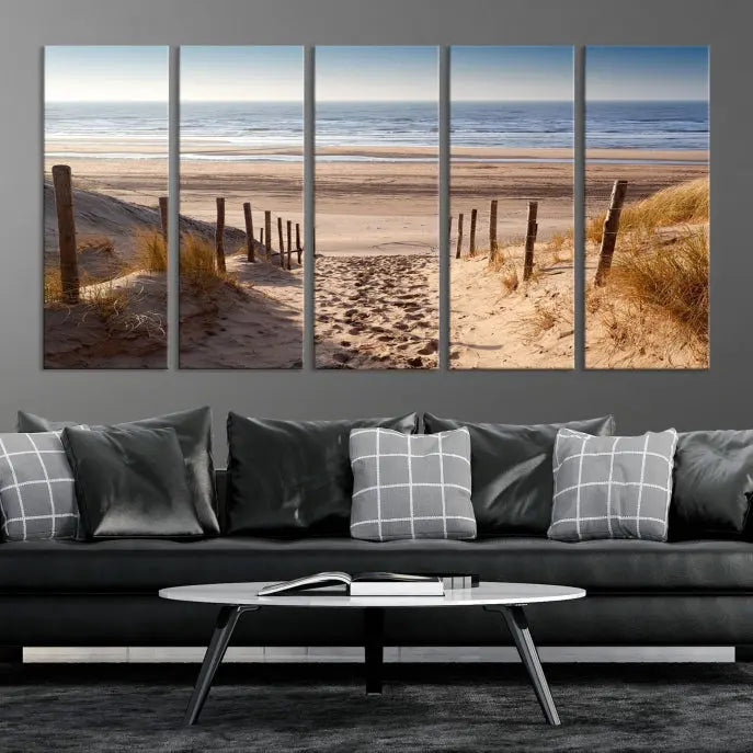 The "Serene Beach Path Canvas – Coastal Landscape Wall Art Triptych – Tranquil Ocean View for Living Room" is tastefully displayed, adding a beautiful coastal touch to the room's ambiance.