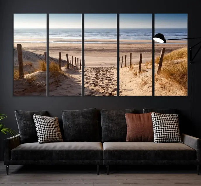 The "Serene Beach Path Canvas – Coastal Landscape Wall Art Triptych – Tranquil Ocean View for Living Room" is tastefully displayed, adding a beautiful coastal touch to the room's ambiance.