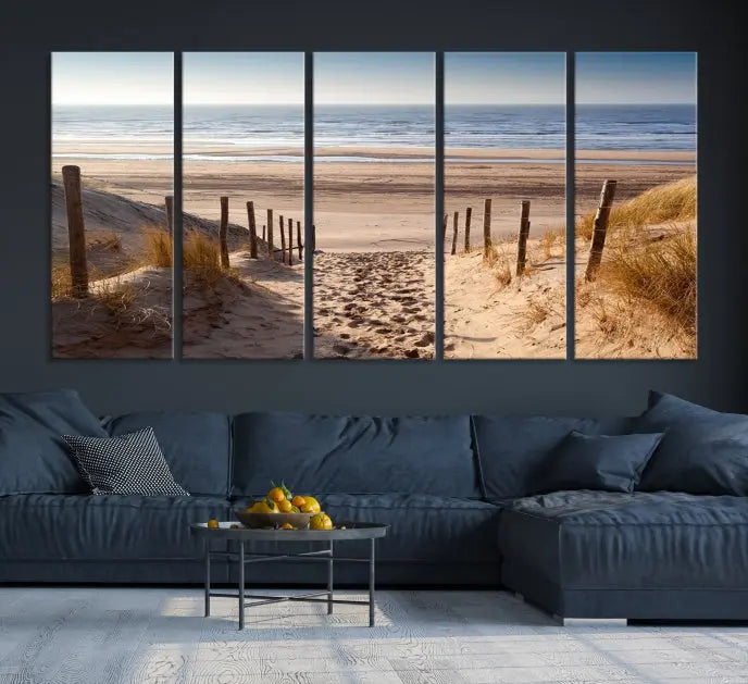 The "Serene Beach Path Canvas – Coastal Landscape Wall Art Triptych – Tranquil Ocean View for Living Room" is tastefully displayed, adding a beautiful coastal touch to the room's ambiance.