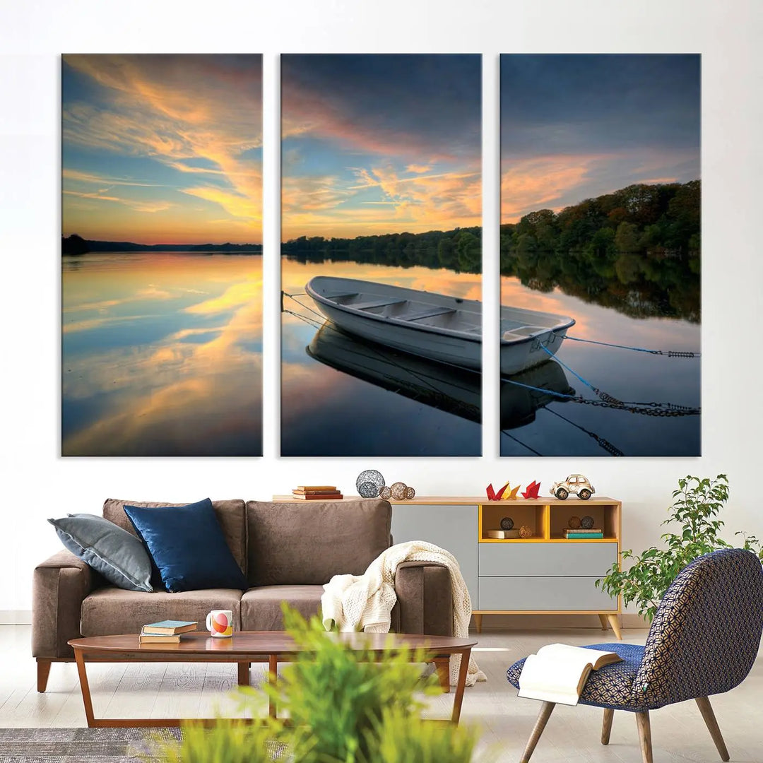 The "Serene Rowboat on Calm Lake Triptych Canvas Art" presents a tranquil landscape featuring a serene rowboat tied to the dock at sunset. This giclee wall art captures the peaceful reflections of a vibrant sky and surrounding trees, making it a masterpiece for any home or office.