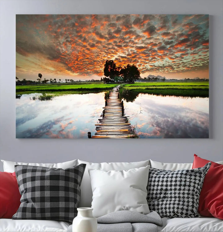 Serene sunset wooden bridge triptych canvas art. Giclee print with vibrant sunset reflections, perfect for tranquil and scenic spaces.