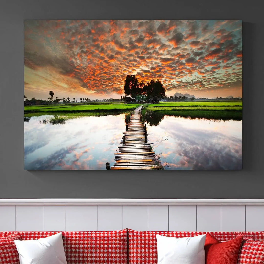 Serene sunset wooden bridge triptych canvas art. Giclee print with vibrant sunset reflections, perfect for tranquil and scenic spaces.