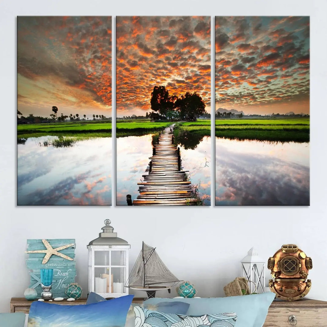 Serene sunset wooden bridge triptych canvas art. Giclee print with vibrant sunset reflections, perfect for tranquil and scenic spaces.