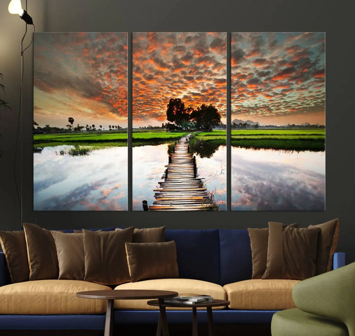 Serene sunset wooden bridge triptych canvas art. Giclee print with vibrant sunset reflections, perfect for tranquil and scenic spaces.