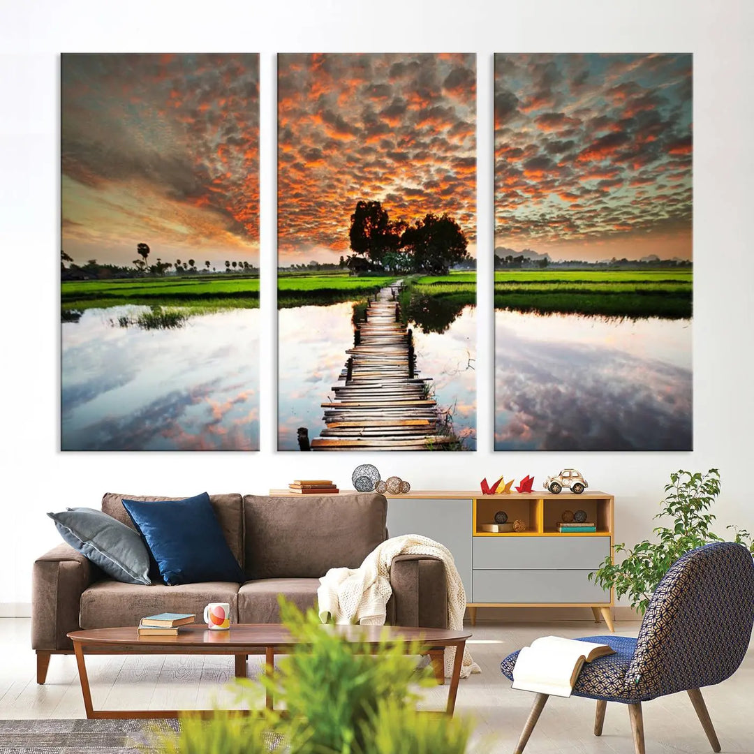 Serene sunset wooden bridge triptych canvas art. Giclee print with vibrant sunset reflections, perfect for tranquil and scenic spaces.