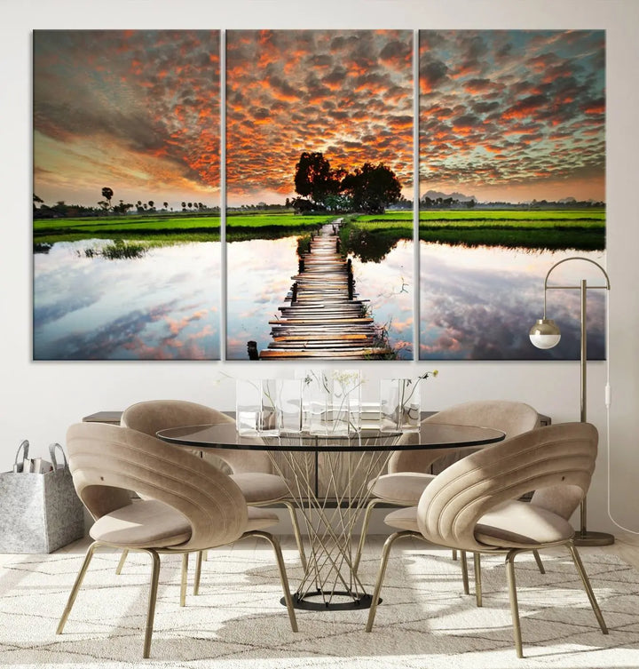 Serene sunset wooden bridge triptych canvas art. Giclee print with vibrant sunset reflections, perfect for tranquil and scenic spaces.