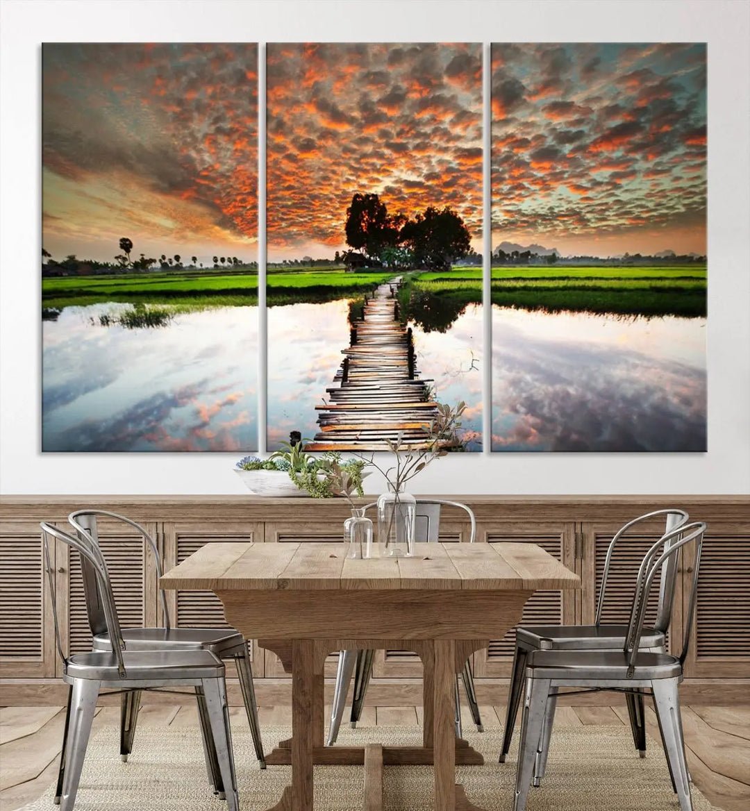 Serene sunset wooden bridge triptych canvas art. Giclee print with vibrant sunset reflections, perfect for tranquil and scenic spaces.