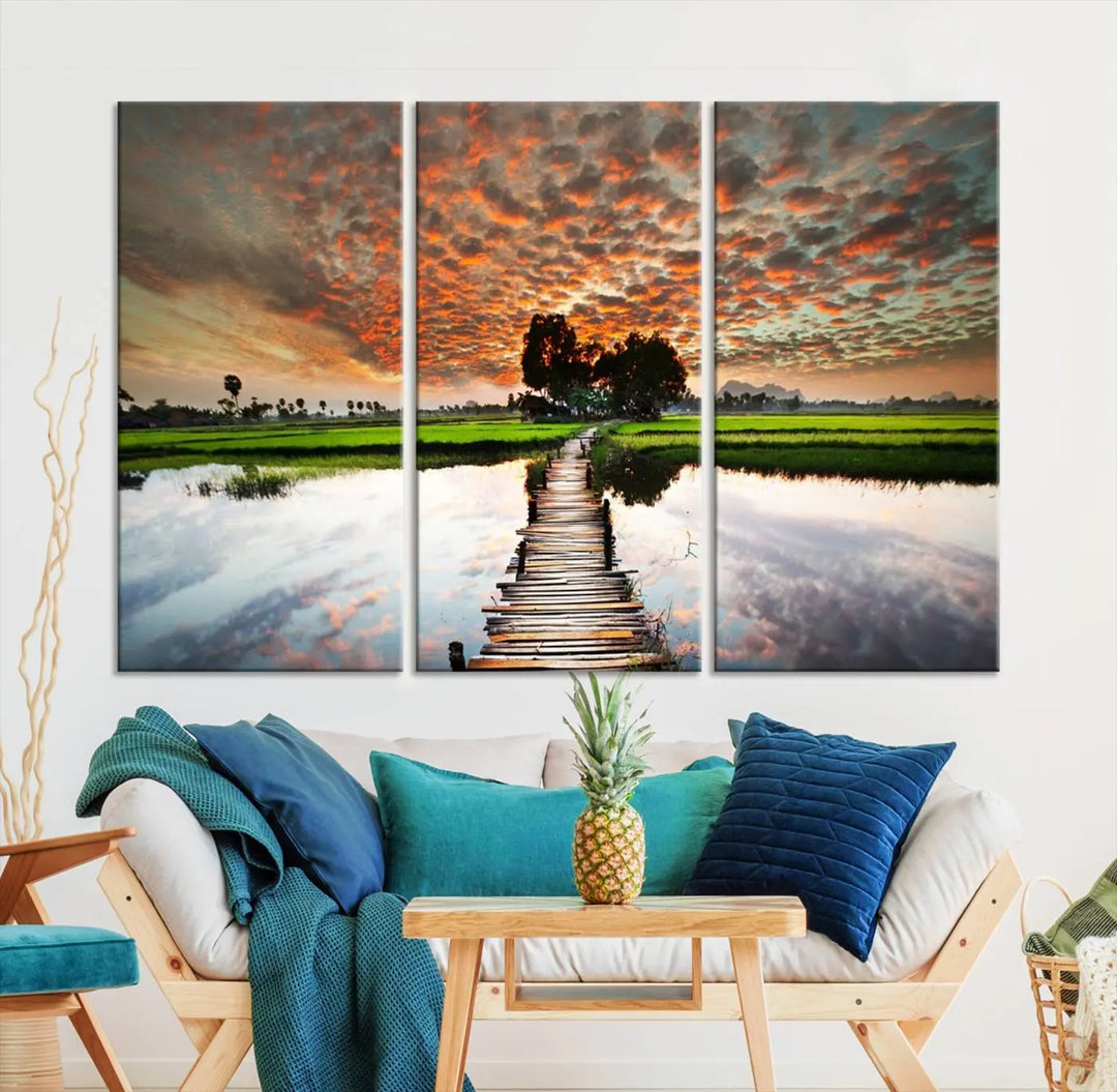 Serene sunset wooden bridge triptych canvas art. Giclee print with vibrant sunset reflections, perfect for tranquil and scenic spaces.