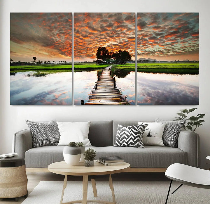 Serene sunset wooden bridge triptych canvas art. Giclee print with vibrant sunset reflections, perfect for tranquil and scenic spaces.