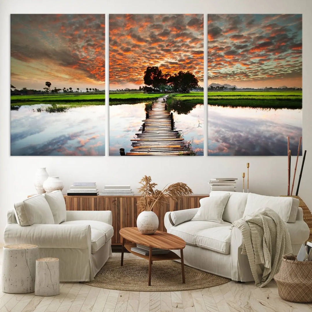 Serene sunset wooden bridge triptych canvas art. Giclee print with vibrant sunset reflections, perfect for tranquil and scenic spaces.