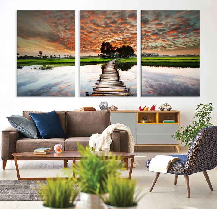 Serene sunset wooden bridge triptych canvas art. Giclee print with vibrant sunset reflections, perfect for tranquil and scenic spaces.