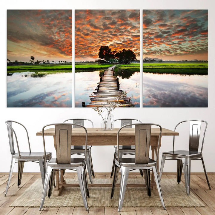 Serene sunset wooden bridge triptych canvas art. Giclee print with vibrant sunset reflections, perfect for tranquil and scenic spaces.