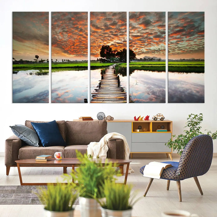 Serene sunset wooden bridge triptych canvas art. Giclee print with vibrant sunset reflections, perfect for tranquil and scenic spaces.