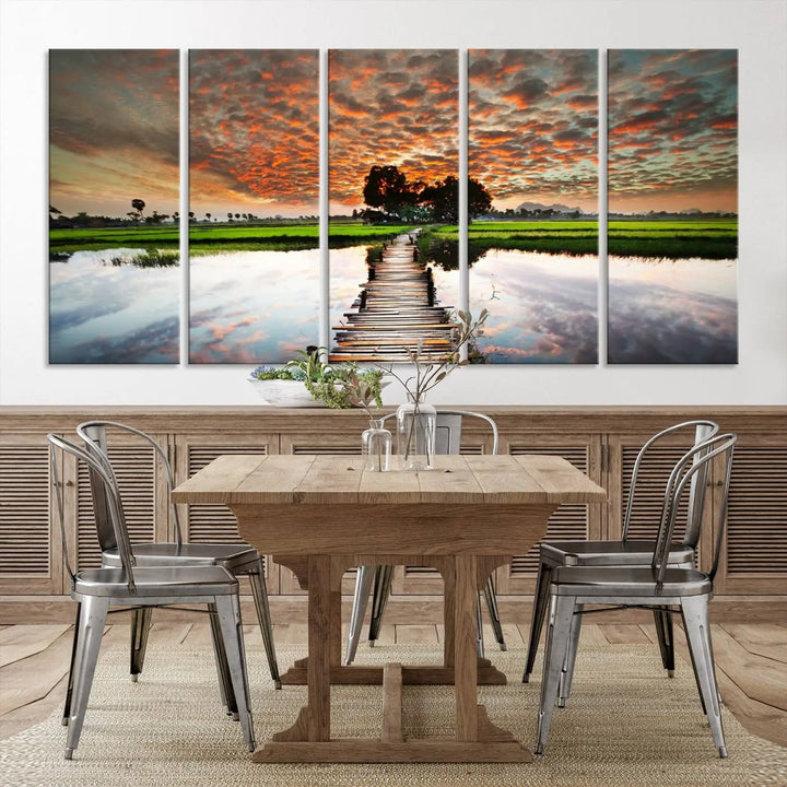 Serene sunset wooden bridge triptych canvas art. Giclee print with vibrant sunset reflections, perfect for tranquil and scenic spaces.