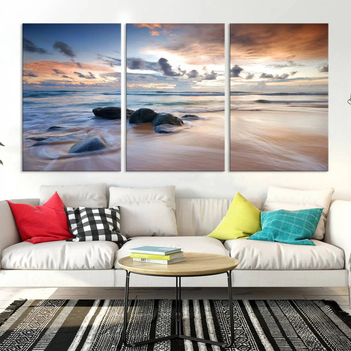 The "Serene Weather On The Beach Wall Art Canvas Print," featuring a tranquil beach scene with rocks and waves, is ready to hang and enjoy.