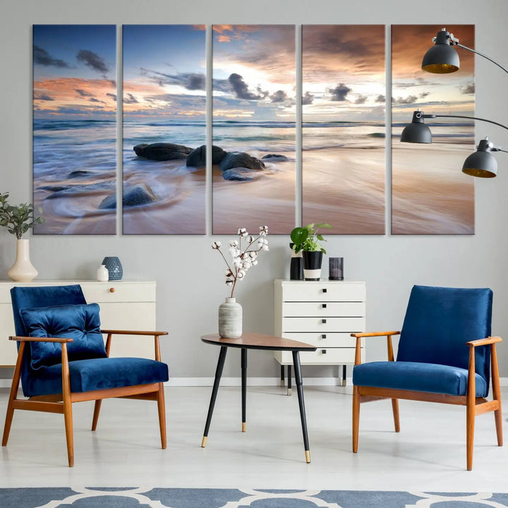 The "Serene Weather On The Beach Wall Art Canvas Print," featuring a tranquil beach scene with rocks and waves, is ready to hang and enjoy.