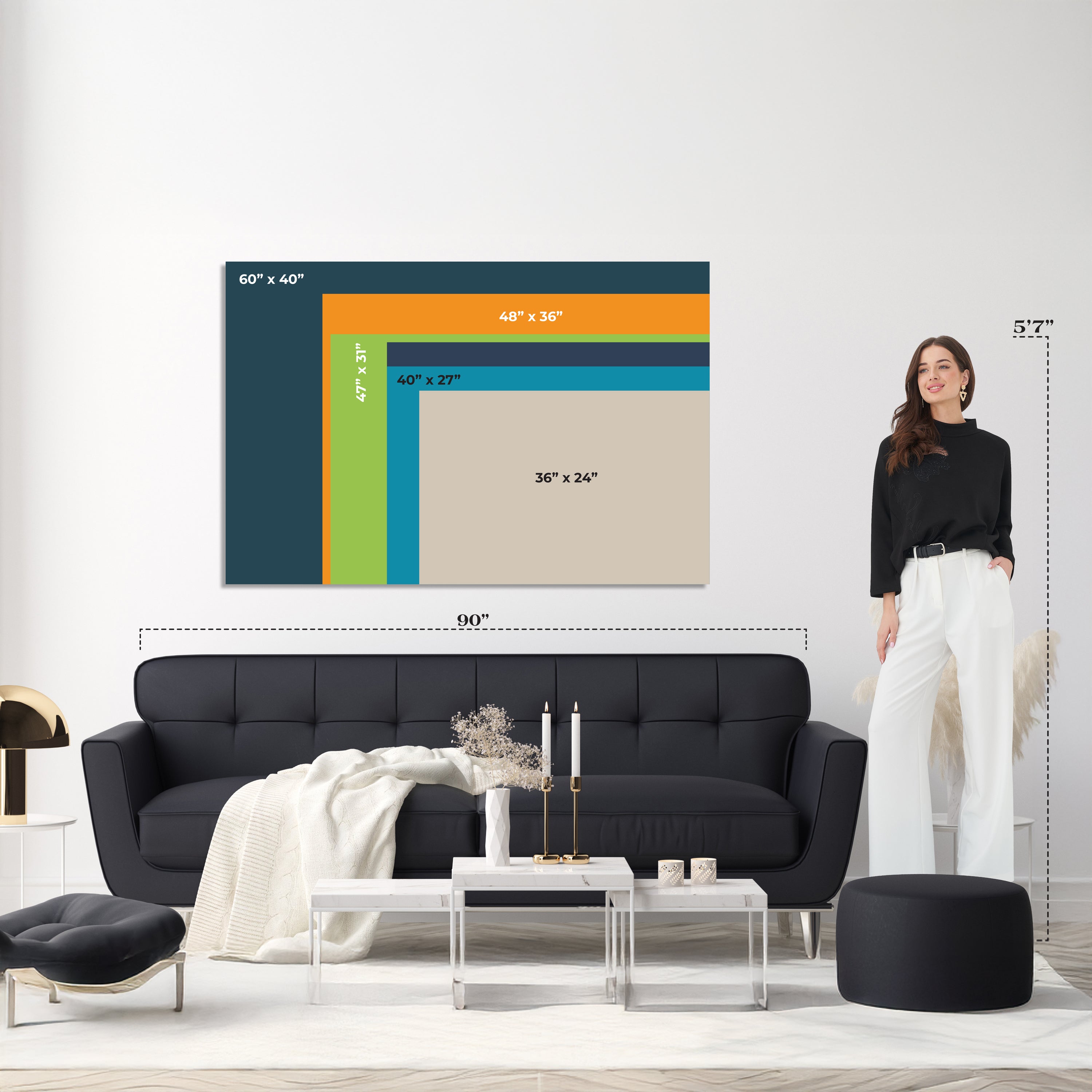 Woman standing next to a wall with framed art and sofa, showing dimensions.