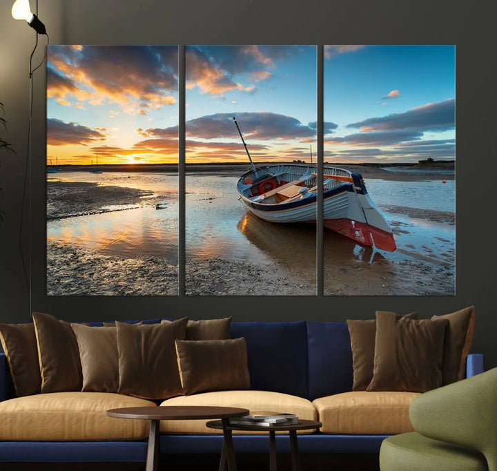 The "Small Boat At The Beach Sunset Wall Art Canvas Print," a three-panel masterpiece crafted on museum-quality canvas, hangs elegantly.