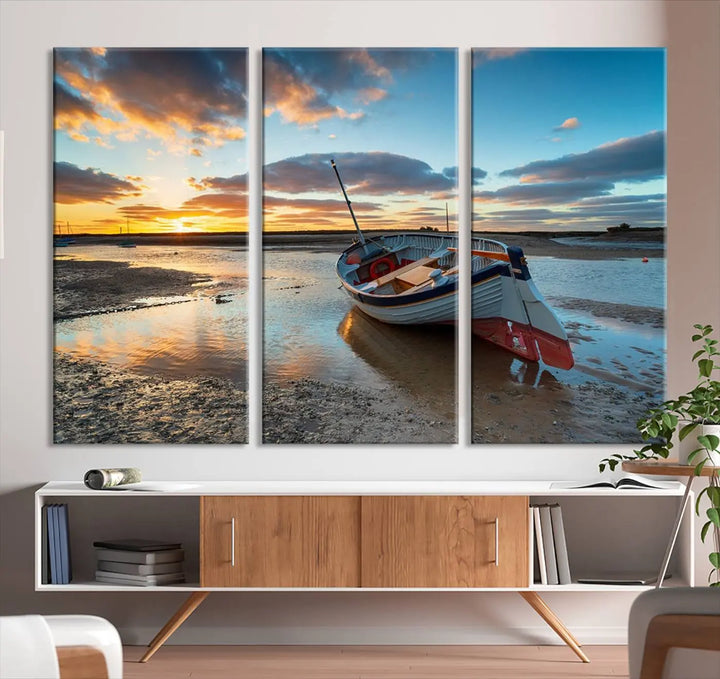 The "Small Boat At The Beach Sunset Wall Art Canvas Print," a three-panel masterpiece crafted on museum-quality canvas, hangs elegantly.