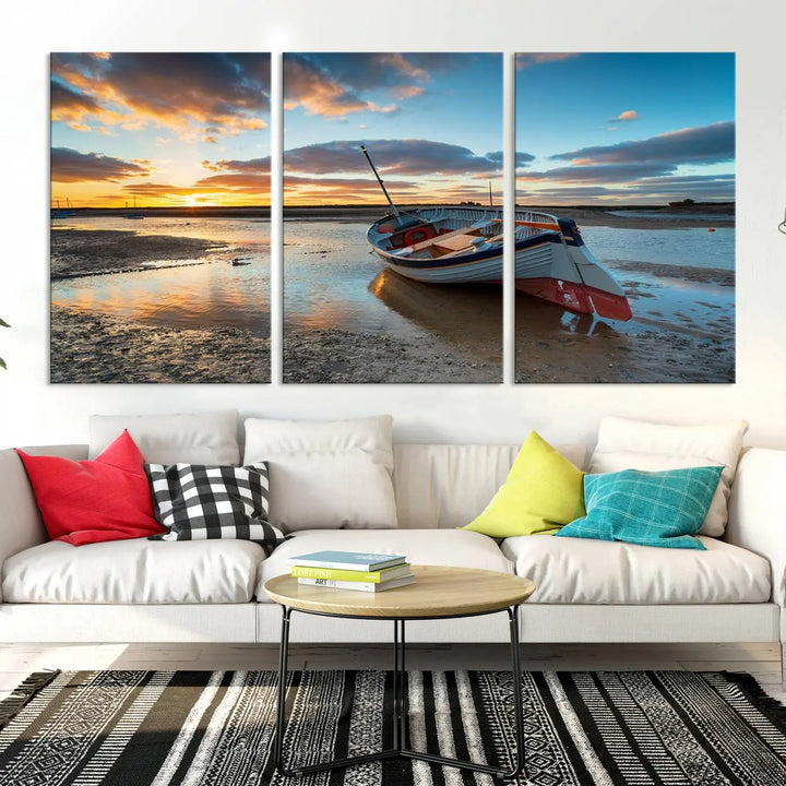 The "Small Boat At The Beach Sunset Wall Art Canvas Print," a three-panel masterpiece crafted on museum-quality canvas, hangs elegantly.