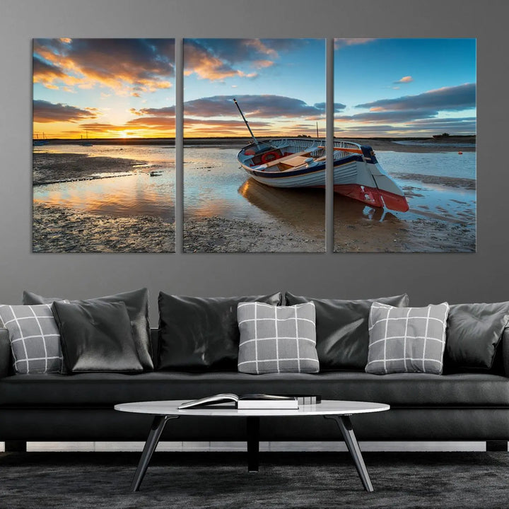 The "Small Boat At The Beach Sunset Wall Art Canvas Print," a three-panel masterpiece crafted on museum-quality canvas, hangs elegantly.