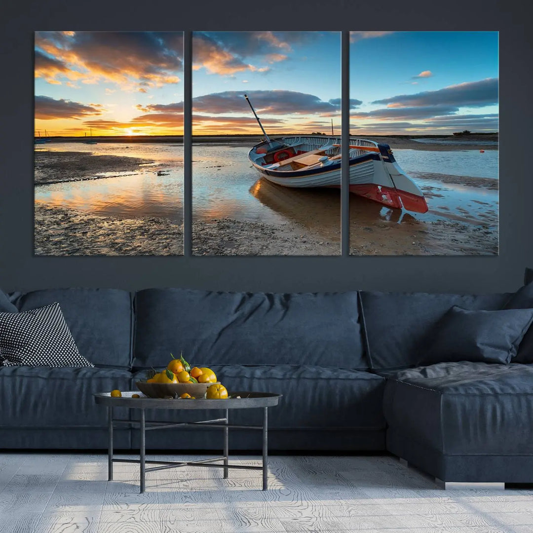 The "Small Boat At The Beach Sunset Wall Art Canvas Print," a three-panel masterpiece crafted on museum-quality canvas, hangs elegantly.