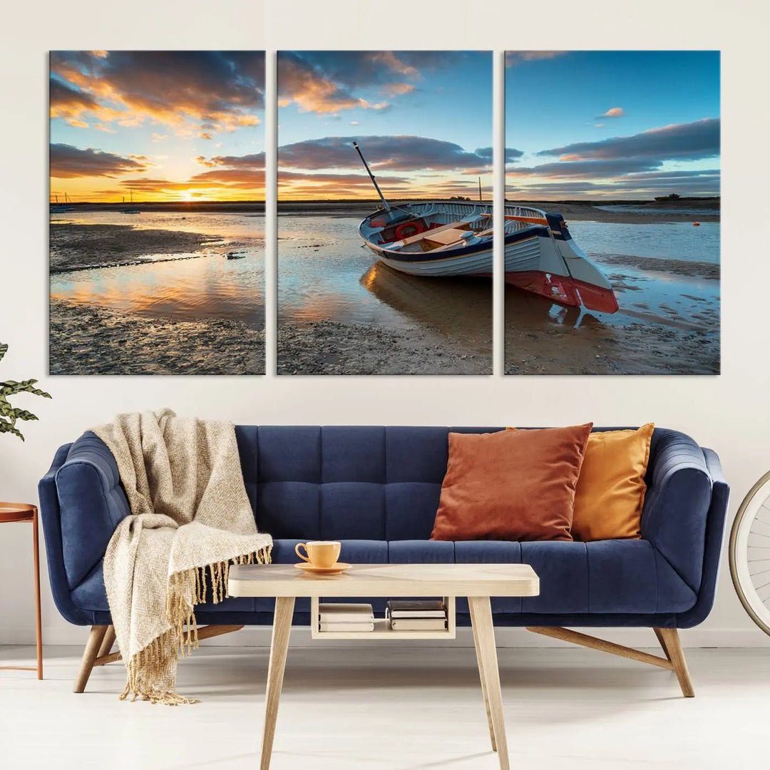 The "Small Boat At The Beach Sunset Wall Art Canvas Print," a three-panel masterpiece crafted on museum-quality canvas, hangs elegantly.