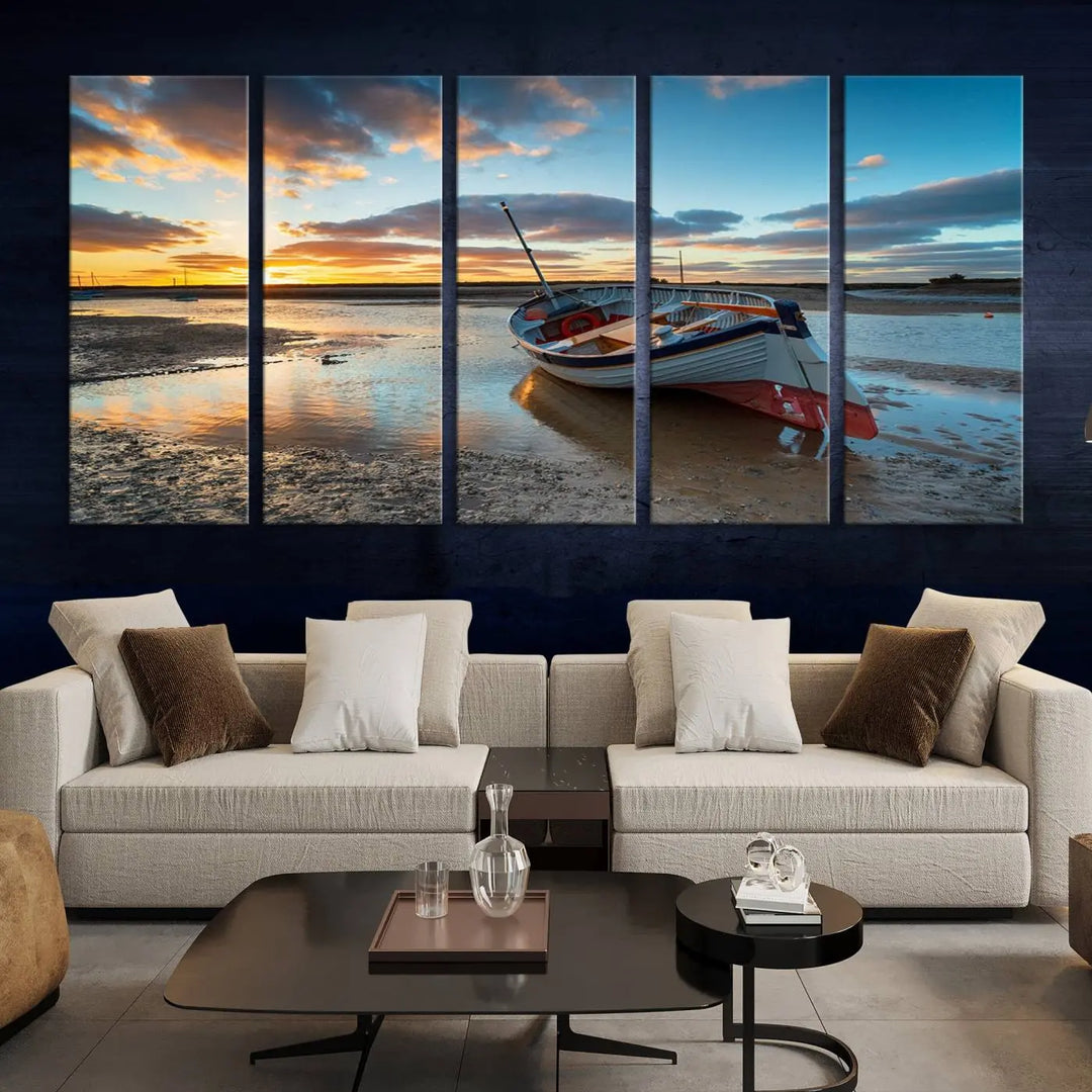 The "Small Boat At The Beach Sunset Wall Art Canvas Print," a three-panel masterpiece crafted on museum-quality canvas, hangs elegantly.