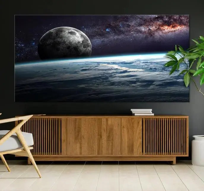 The Space and Planet Canvas Print, a triptych showcasing Earth and the Moon from space on museum-quality canvas with UV-protective coating, hangs prominently in the room.